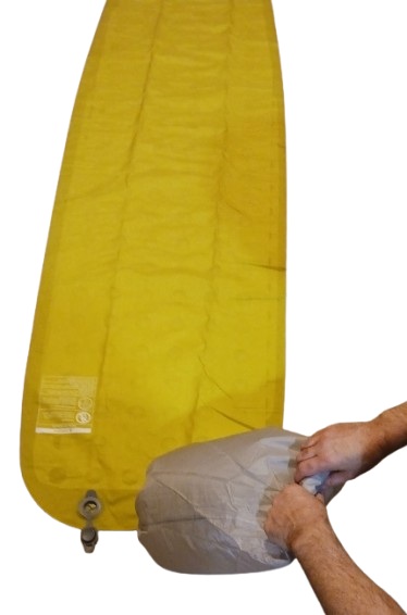 Learn about Sleeping Pads for Backpacking Sleeping-pad Pump Sack Being Rolled Up